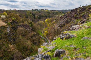 Fototapeta na wymiar Steep rocks and valley Divoka Sarka in Prague, spring time. Wild nature park in the city.