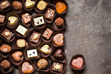 The range of chocolates, sweets on dark background