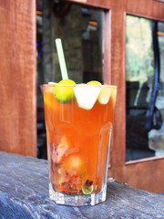Glass cup of fruit tea on wooden table