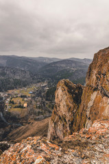 Autumn landscape - rocks and mountains, fog and clouds.