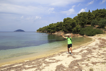 Tourists men on Aegean coast of Sithonia peninsula