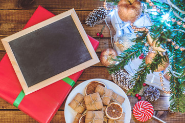 Christmas tree, toys and gifts with a clean slate for text top view