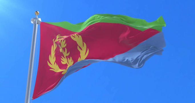 Flag of Eritrea waving at wind with blue sky in slow, loop