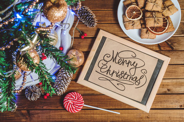 Christmas tree, toys and gifts and a card that says 