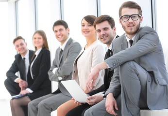 business team sitting in the lobby of the office