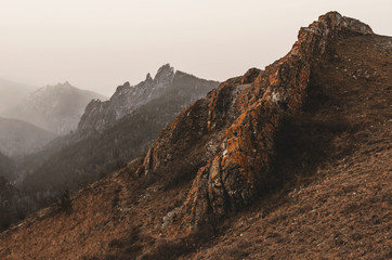 Autumn landscape - rocks and mountains, fog and clouds.