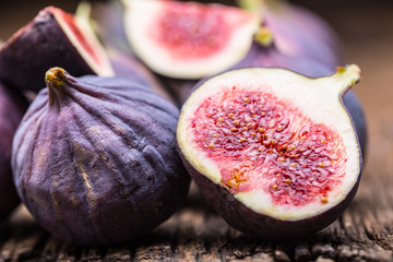Figs. A few figs in a bowl on an old wooden background