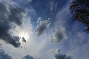 Sun shining through light cloud summer blue sky Australia