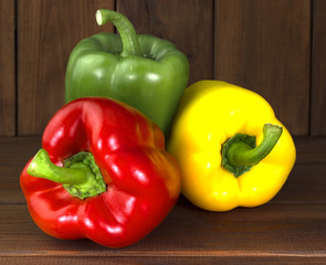 Juicy beautiful Bulgarian pepper on a wooden background