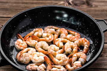 Grilled prawn on pan, preparing dish with crustacean, mediterranean food concept