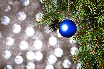 Decorated with christmas balls Christmas tree on a blurry, sparkling and fabulous background.