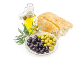 Black and green olives, olive branch, ciabatta and olive oil