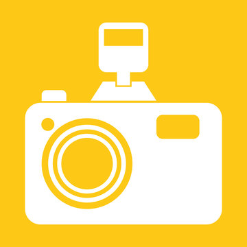 camera with flash on a yellow background