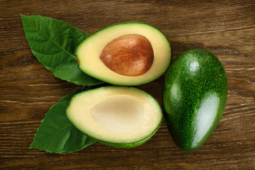 Avocado with leaves on a dark wooden background.