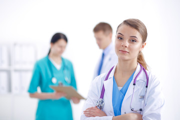 Attractive female doctor in front of medical group.