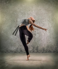 Fototapeta na wymiar Woman dancer, in beautiful dynamic jump action figure on the gru
