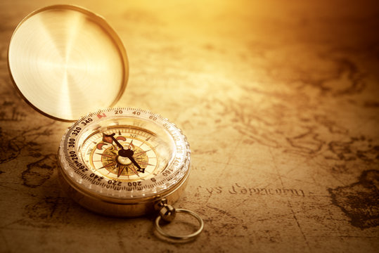 Old vintage compass on vintage map