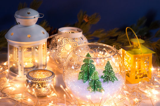 Still life pocture with Christmas lanterns and small pine trees miniature