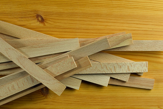 Heap of small wooden sticks, material for model making and doll house projects. 