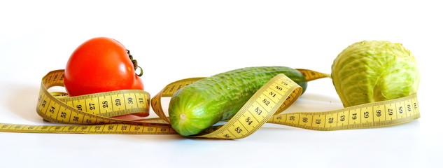 yellow measuring tape and diet vegetables, cabbage, cucumber, tomato isolated on white background