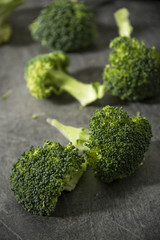 Broccoli pieces on a granite tabletop. Cooking preparation. Healthcare concept.