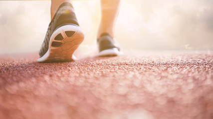 Runner athlete feet running on treadmill. workout wellness concept.