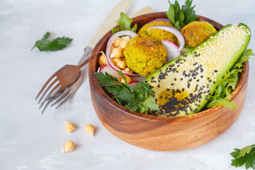 Buddha bowl of vegetable salad with baked falafel and avocado.