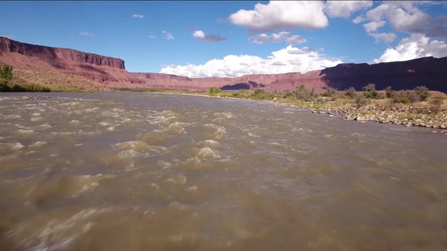 Aerial low shot above the colorado river in desert