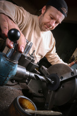 Fototapeta premium Metal worker working on lathe