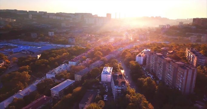 Flying backwards, aerial view of Vladivostok at sunrise, Mazda Sollers building