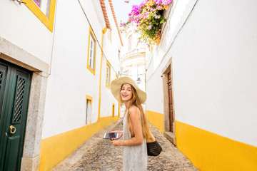 Young woman traveling on the street in the old town of Evora in Portugal