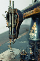 Vintage sewing machine before repair. Old style tinted photo.
