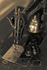 Vintage sewing machine before repair. Old style tinted photo.