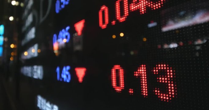 Stock market display board in city at night