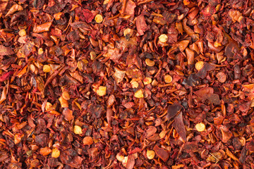 hot chili pepper flakes  spice as a background, natural seasoning texture