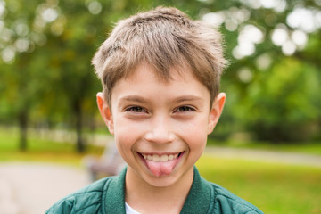 Portrait of a boy showing the tongue © savelov