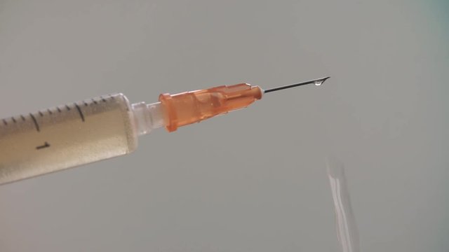 Medical syringe with drugs on blurry background