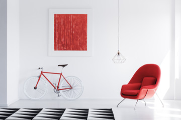 Red armchair in bright interior