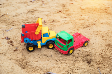 Fototapeta na wymiar children's toys trucks imitate a traffic accident