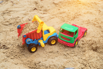 Fototapeta na wymiar children's toys trucks imitate a traffic accident