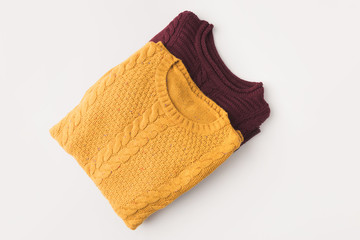 knitted burgundy and yellow sweaters
