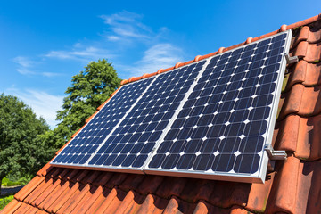 Row of solar collectors  on orange roof