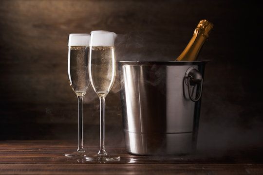 Picture of two wine glasses with sparkling wine, iron bucket