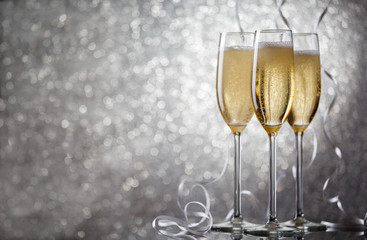 Picture of three glasses with wine on gray background.