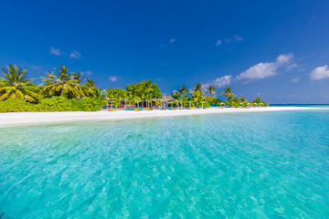Beautiful beach scene in Maldives. Beach bar and blue sea and palm trees