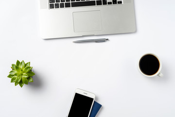 Overhead shot of laptop and accessories on white background with copy space