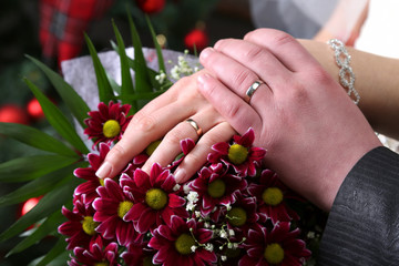 hands of bride and groom near wedding bouquet