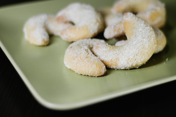Close up of homemade traditional German Christmas cookies called Vanillekipferl, crescent shaped butter cookies with ground almonds and dusted with vanilla sugar