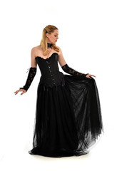 Naklejka premium full length portrait of a blonde girl wearing black gothic gown. standing pose, isolated on white background.