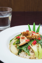 Crispy Pork with Kale served on the table and drinking water a fast food and also has the nutrients from vegetables and pork, which are beneficial to the body and people Thailand like to eat.